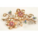 A gold, diamond, ruby, sapphire and emerald brooch, designed as a floral and foliate spray,