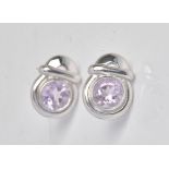 A pair of white gold and amethyst single stone earstuds, each in a hoop shaped and bar design,