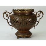 A late 19th century twin handled, gilt metal and copper jardiniere, of baluster form,