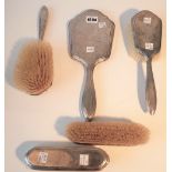 A silver mounted matched five piece part dressing set, comprising; a hand mirror, London 1921,