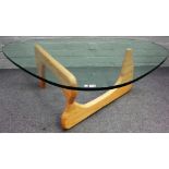 A Noguchi style glass and beech coffee table, 130cm wide x 40cm high.