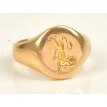 An 18ct gold oval signet ring, engraved with a lion crest and presentation inscribed, London 1906,