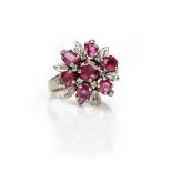 A ruby and diamond cluster ring, designed as a stylized flowerhead,