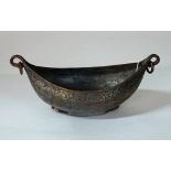 A Safavid tinned copper kachkol, possibly 18th century, of boat shape with ring handles,