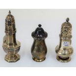 A George I style silver octagonal castor, London 1908, 17cm high, and two other silver castors,