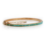 A gold and turquoise set oval hinged bangle,