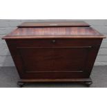 A Regency mahogany sarcophagus shaped cellarette, with moulded panel front on bun feet,