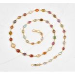 A gold and varicoloured gemstone necklace,