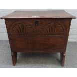 A small 17th century and later oak plank coffer, with carved front panel, on slab end supports,