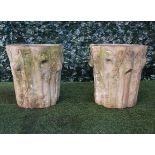 A pair of terracotta jardinieres naturally cast as ivy clad tree trunks, 46cm wide x 49cm high.