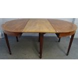 A George III mahogany 'D' end dining table, the cross banded top on channelled tapering supports,
