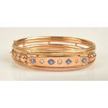 A late Victorian 9ct gold, sapphire and diamond set oval hinged bangle,