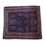 A Baluchistan rug, the indigo field with rectangular medallions,