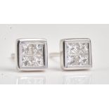 A pair of white gold and diamond earstuds, each mounted with four princess cut diamonds,