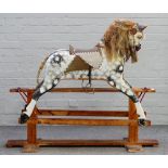 A wooden dapple grey painted rocking horse, early 20th century, on a stained pine base,