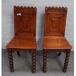 A pair of Victorian oak Gothic revival hall chairs,