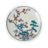 A Chinese doucai style small porcelain plate, painted with pine, prunus and bamboo,