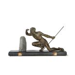 A 20th century patinated spelter sculpture of a kneeling warrior holding a spear,