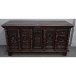 A French 16th century style oak cabinet with pair of profile carved figural doors divided by