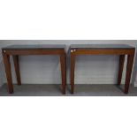 A pair of modern consoles each with rectangular polished marble tops on four tapering hardwood