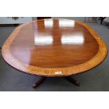 Possibly Brights of Nettlebed, a George III style satinwood banded circular extending dining table,