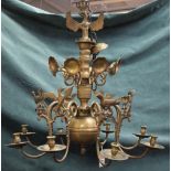 A brass eight light chandelier, the scroll branches having bird finials, in the 17th century style,