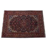 A Kashan rug, Persian, the indigo field with a madder and pink medallion,