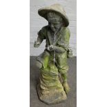 A lead figure group of a young boy fishing, 80cm high.