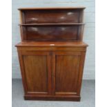 A Regency mahogany chiffonier, the two tier shelf back over pair of cupboards on plinth base,