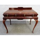 A George II style figured walnut side table, with three cushion frieze drawers,
