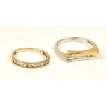 An 18ct two colour gold and diamond set ring, mounted with a row of seven circular cut diamonds,