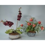 An oval glazed pottery jardiniere containing artificial moth orchids,