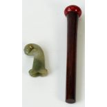 A jade dagger hilt, length 8cm, and a composition amber coloured parasol handle, length 24cm.