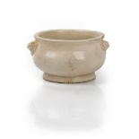 A Chinese white pottery censer, probably 17th/18th century, of bombé form with lion mask handles,