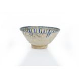A Persian pottery bowl, 13th/14th century, with straight flared sides,