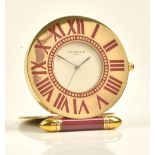 A Cartier Paris quartz folding travelling clock, of gilt metal circular form,