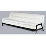 A mid century Swedish design Dux four-seat sofa, with black frame and sculptural sides,