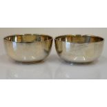 Two similar silver circular bowls, by Walker & Hall, Sheffield 1916 and 1917, diameter of each 11cm,