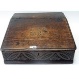 A 17th century oak slope front bible box, detailed E+B 1689, 58cm wide x 23cm high.