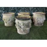 A set of four Vicenza stone jardinieres with fruit and leaf moulded bodies,