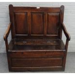 An 18th century oak box seat open arm settle, with triple panel back, 100cm wide x 109cm high.