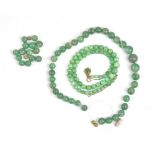 A single row necklace of graduated spherical jade beads, on a jade set clasp, gross weight 27.