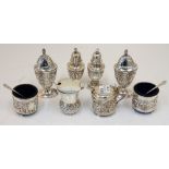 A group of silver condiments comprising; a Scottish mustard pot, designed as a thistle,