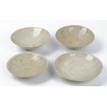 Three Chinese qingbai bowls, probably Song dynasty, each carved with foliate scrolls, 16cm to 17.