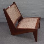 After Pierre Jeaneret, a teak and cane low easy armchair, 55cm wide x 68cm high.