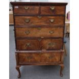 A George I figured walnut chest on stand with two short over three long graduated drawers,
