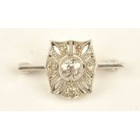 A diamond brooch in a pierced curved panel shaped design,