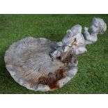 A lead bird bath modelled as a cherub sitting on a shell, 50cm wide x 30cm high.