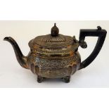 A silver teapot, with partly fluted decoration below a floral and foliate engraved band,