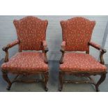 A pair of French 19th century walnut fauteuils with shaped backs and open arms on carved cabriole
